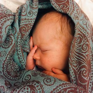 Close-up of baby lying on bed