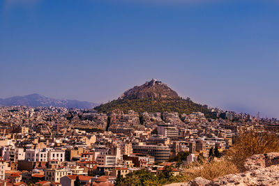 High angle view of townscape against clear blue sky