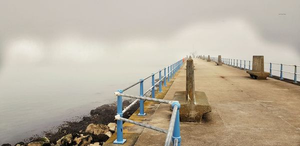 Pier over sea against sky