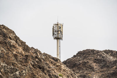 Low angle view of communications tower against sky