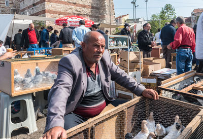 Rear view of people working at market