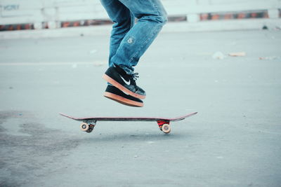 Low section of man standing on skateboard