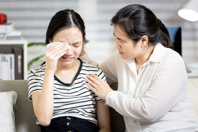 Mother consoling crying daughter