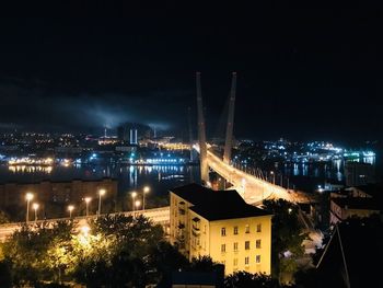 High angle view of illuminated buildings against sky at night