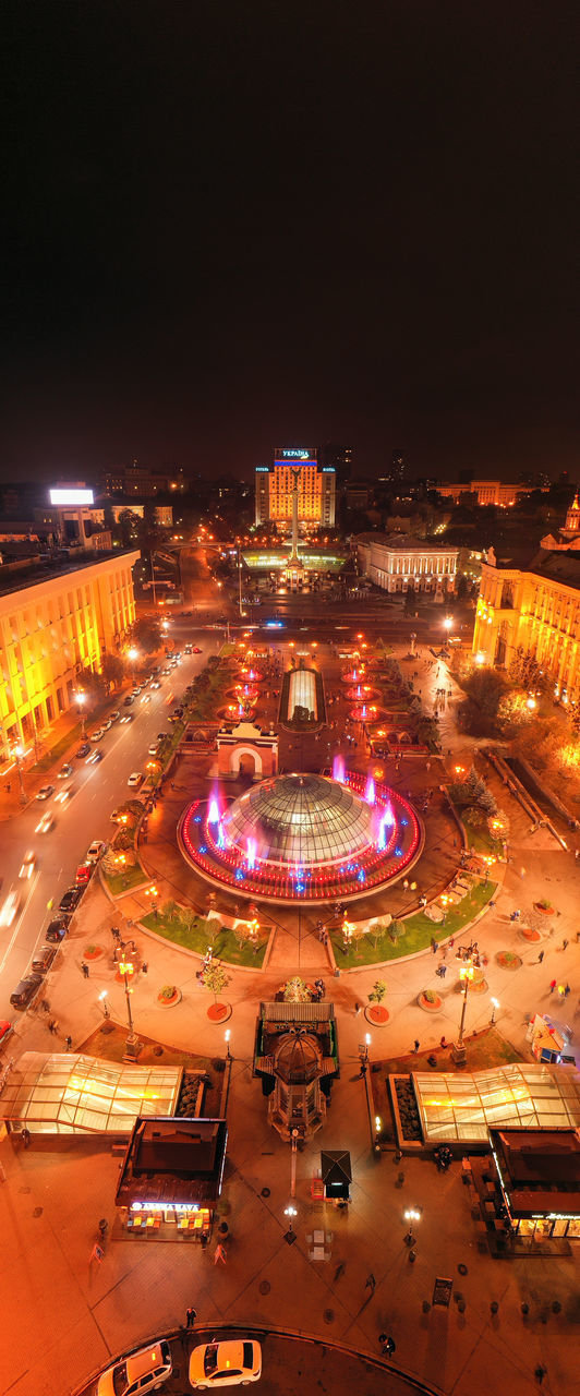 HIGH ANGLE VIEW OF ILLUMINATED CITY AGAINST SKY