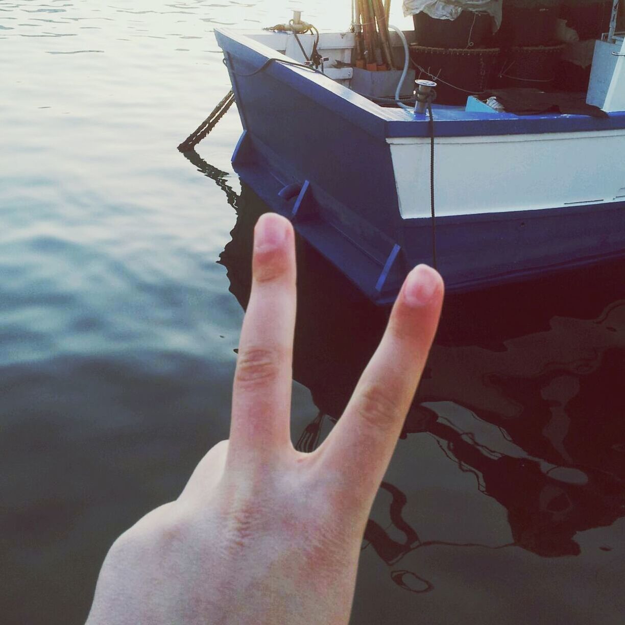person, part of, cropped, water, personal perspective, human finger, holding, unrecognizable person, lake, lifestyles, nautical vessel, boat, leisure activity, reflection, close-up, focus on foreground, outdoors