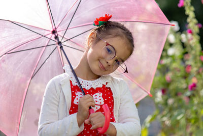 Portrait of a smiling beautiful little girl with umbrella