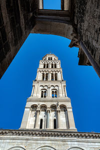 Low angle view of historical building against blue sky