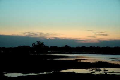 Scenic view of lake against sky during winter