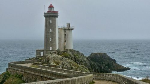 Lighthouse by sea against clear sky in france 