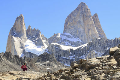 Woman looking at scenic view of mountains against clear sky in patagonia argentina 