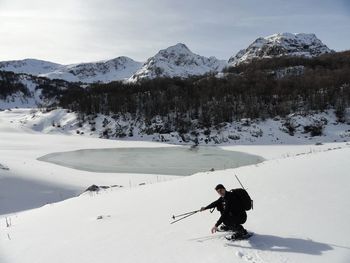 People skiing on snow covered mountain