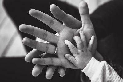 Cropped hands of family at home