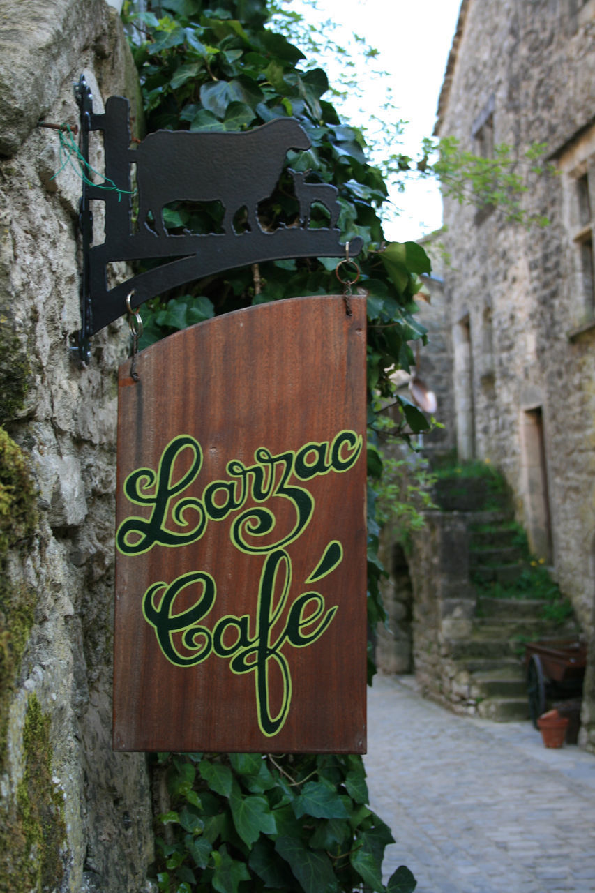 CLOSE-UP OF TEXT ON WALL AGAINST BUILDINGS