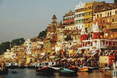 Boats in river with buildings in background