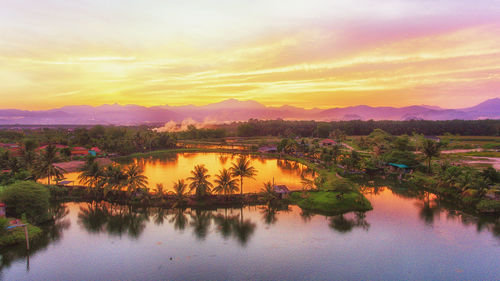 Scenic view of lake against sky during sunset