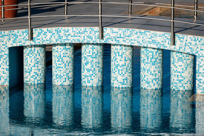 Row of swimming pool against wall