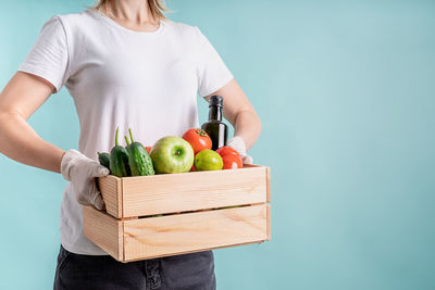 Midsection of woman holding fruits