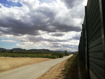 Empty road along countryside landscape