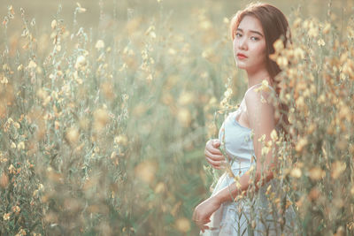 Young woman standing on field