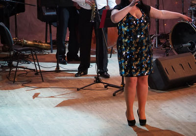 Low section of woman singing on stage