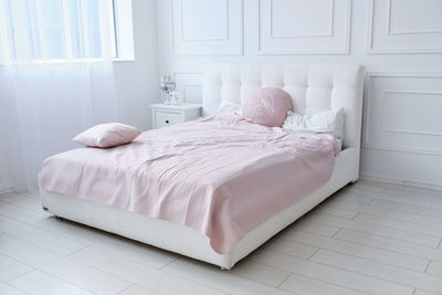 A large double bed in a bright room