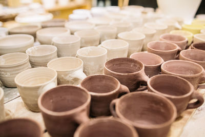 High angle view of clay cups on table