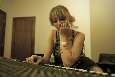 Portrait of a young woman in a recording studio