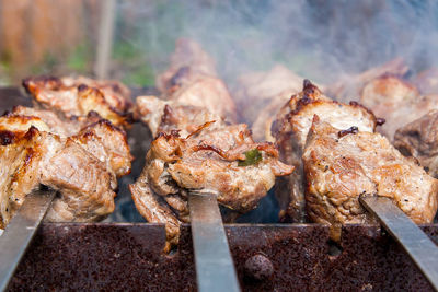 Close-up of meat on barbecue grill