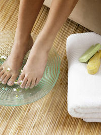 Low section of woman with feet in water at spa