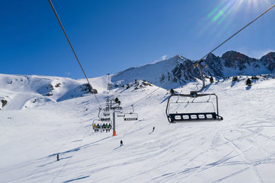 People riding ski lift in ski resort