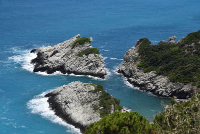 High angle view of rocks by sea against sky