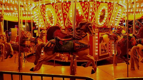 Carousel in amusement park at night