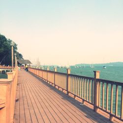 Pier on sea against clear sky