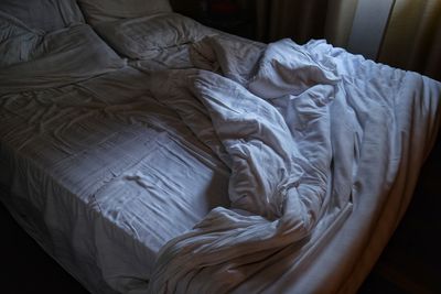 High angle view of messy bed