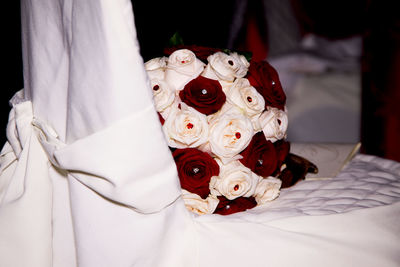 Close-up of white dress on bed