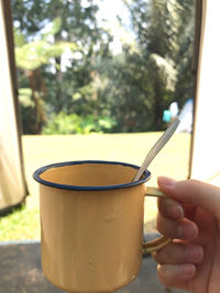 Close-up of hand holding tea cup