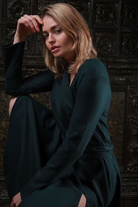 Portrait of young woman while sitting indoors