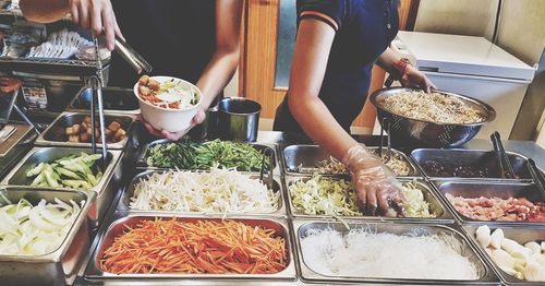 Midsection of people having ice cream