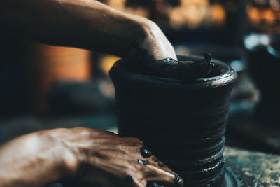 Close-up of man working in tray