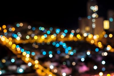 Defocused image of illuminated city at night