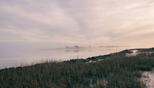 Scenic view of land against sky during sunset