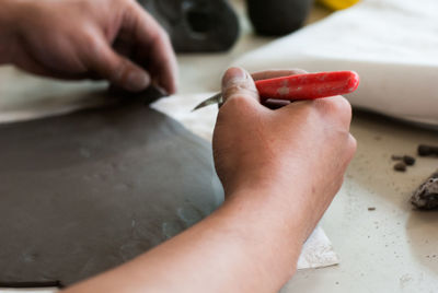 Close-up of human working at workshop