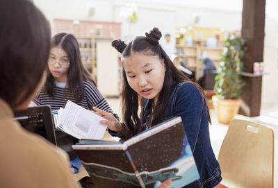 Teenage girl reading book