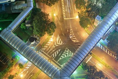 High angle view of covered pedestrian walkway over city street at night