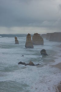 Rocks in sea against sky