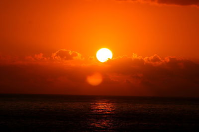 Scenic view of sea against orange sky