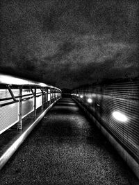 Walkway against sky at night