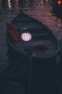 High angle view of illuminated lighting equipment on river at night