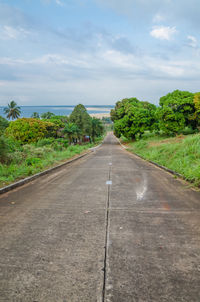 Road by sea against sky